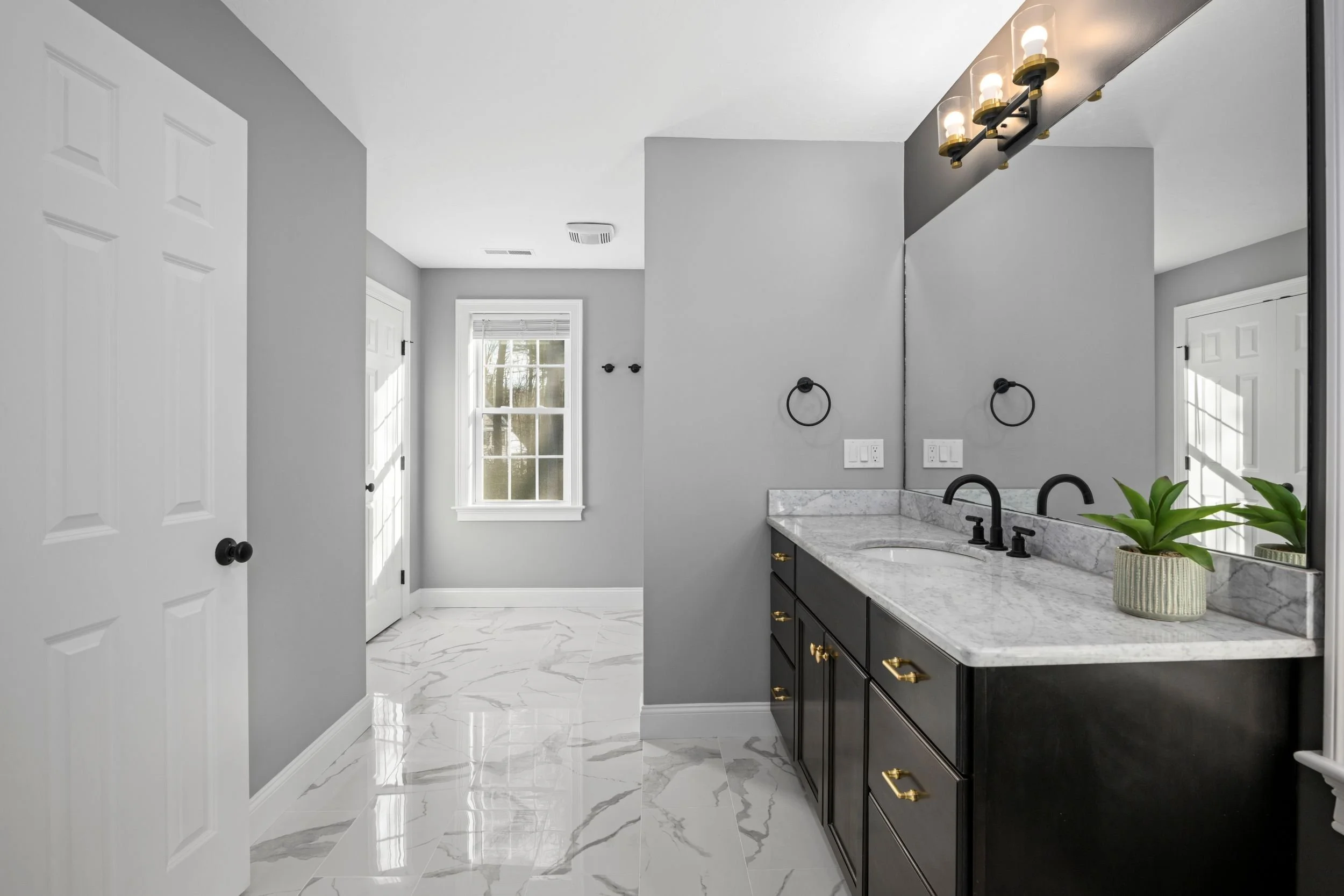 Eden Statuary porcelain tile flooring with double vanity and matte black fixtures in a Boxborough MA master bathroom remodel
