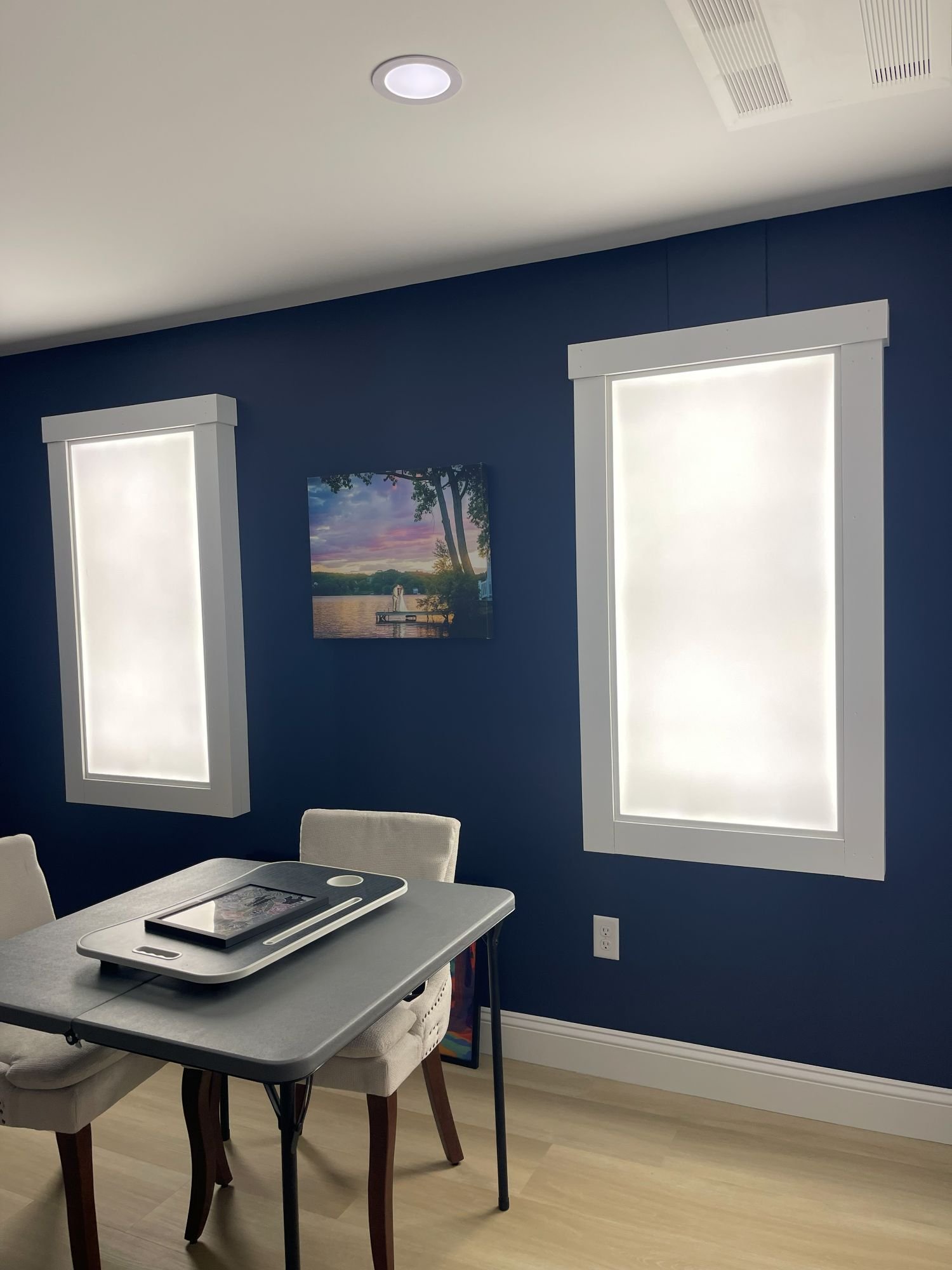 Faux window LED panels turned on in a finished basement remodel in Boxborough, MA