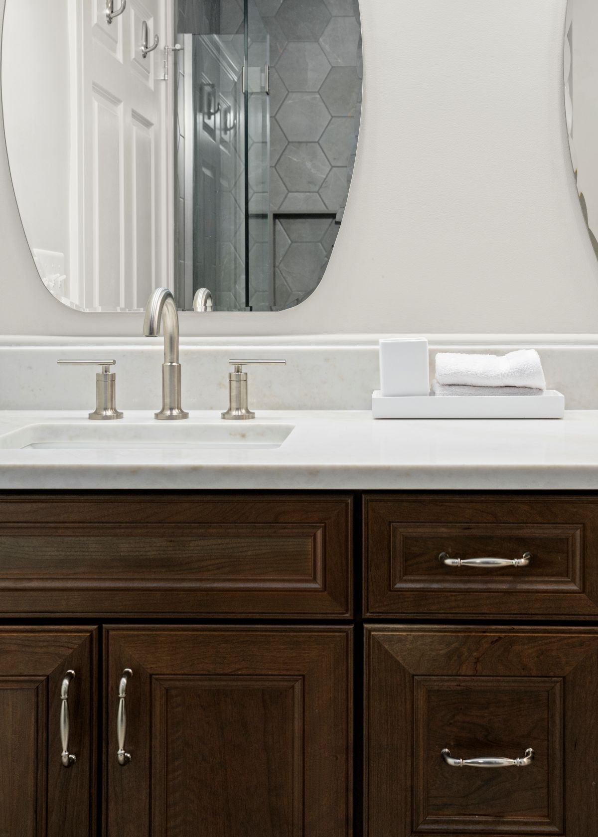 Taj Mahal quartz countertop with Delta Altado faucet and Waypoint Cherry Clove cabinetry with satin nickel Chesapeake pulls, luxury bathroom remodel Holden MA