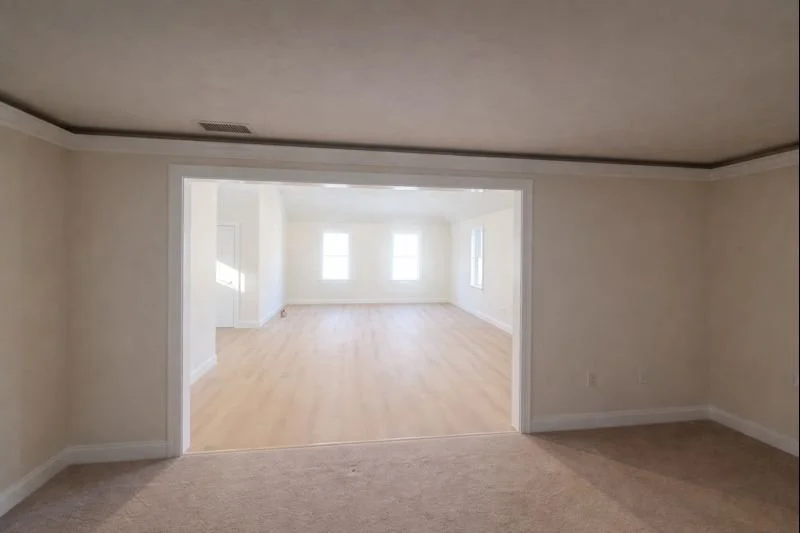 Interior view of a new home addition in Hopkinton, MA showing an open office space with natural light and new flooring