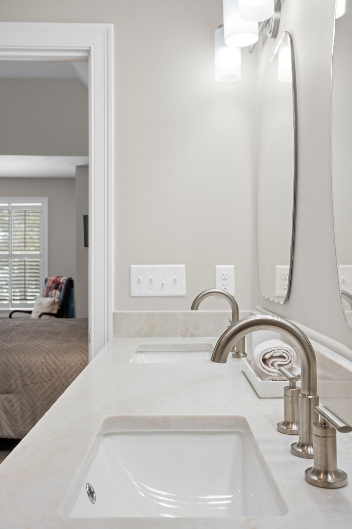 Taj Mahal quartz double vanity countertop with Delta Altado satin nickel faucets and undermount sinks, luxury bathroom remodel Holden MA