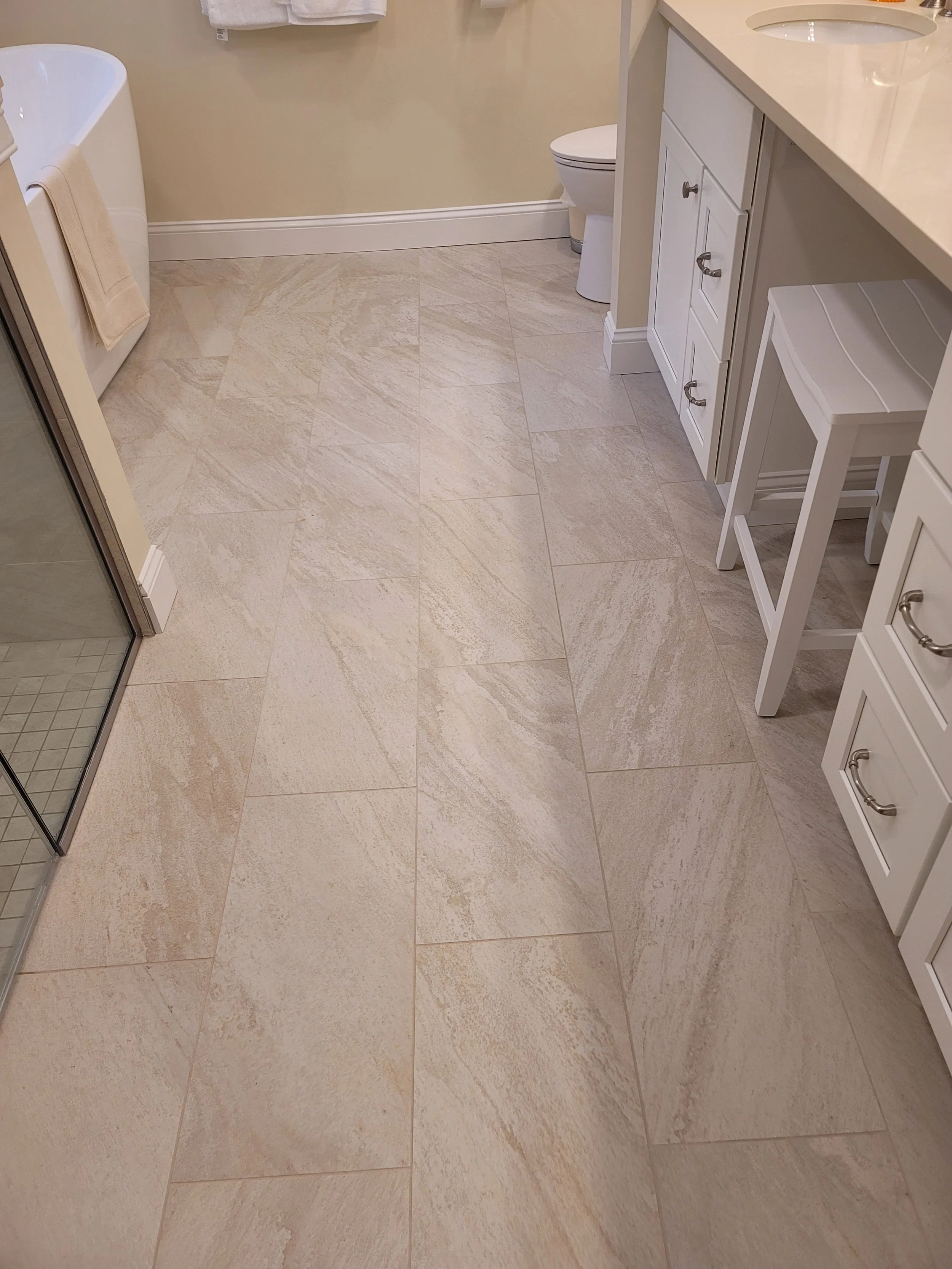 Primary bathroom porcelain tile flooring in Stow MA with large-format rectified tile