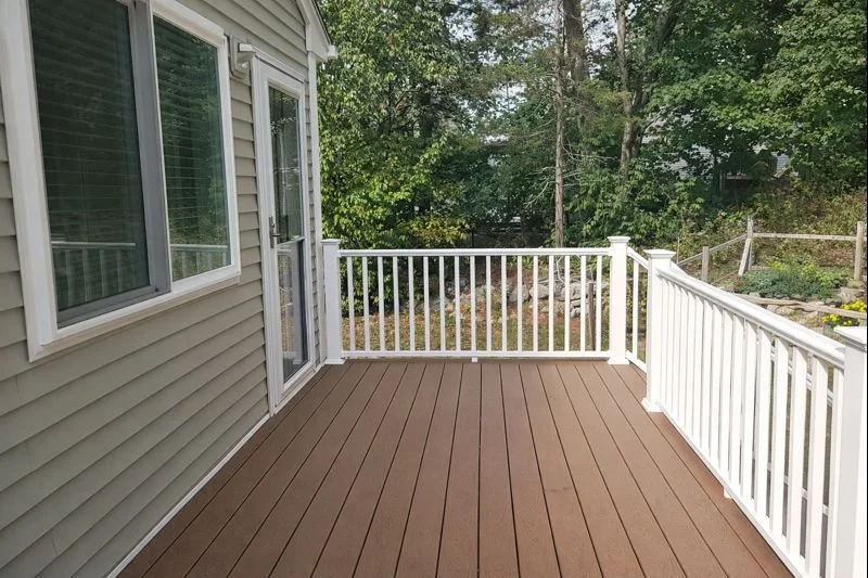 Elevated deck view from family room addition overlooking wooded backyard