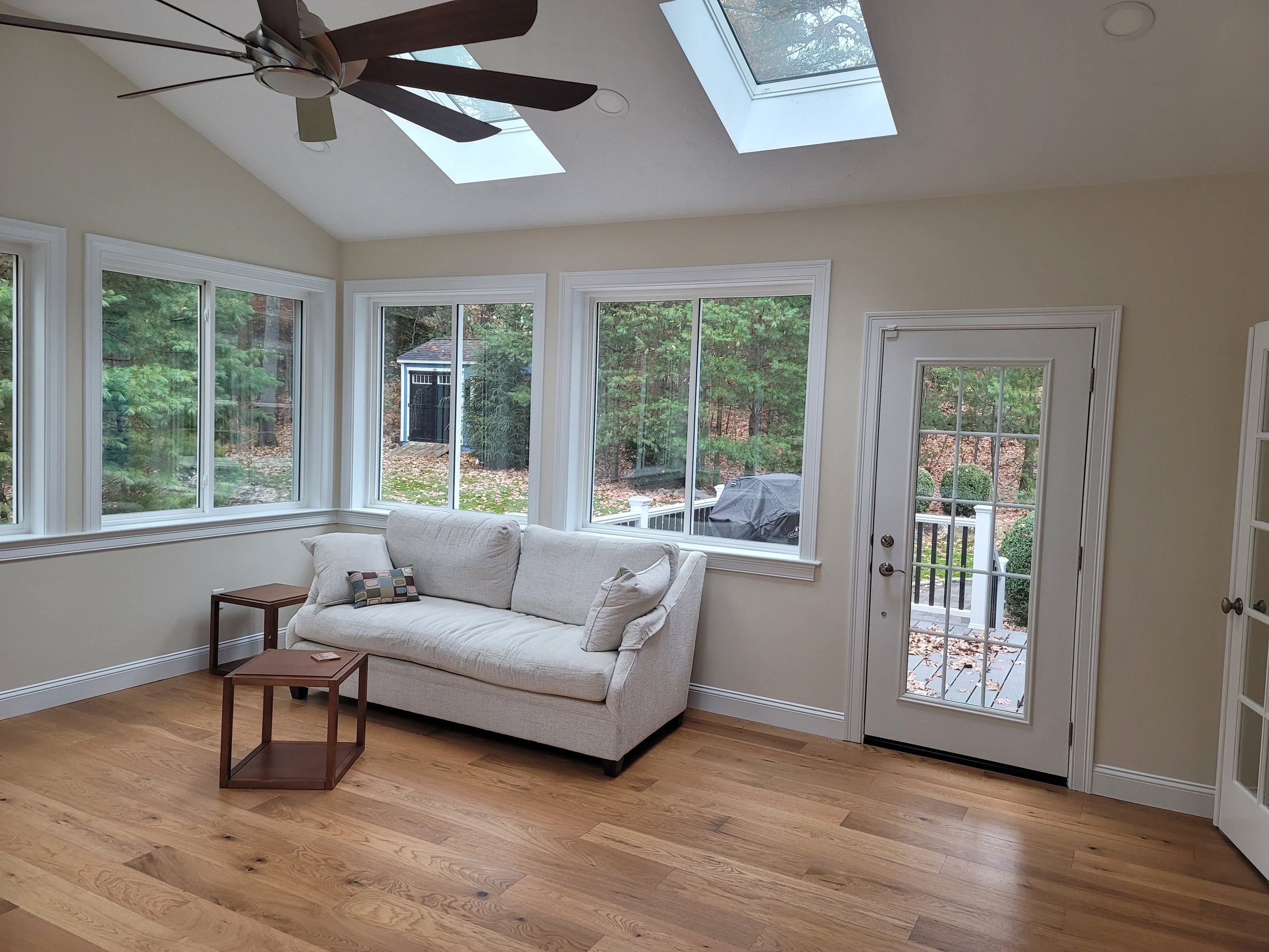 4-season room addition in Stow MA with Velux skylights, ProVia windows, and deck access