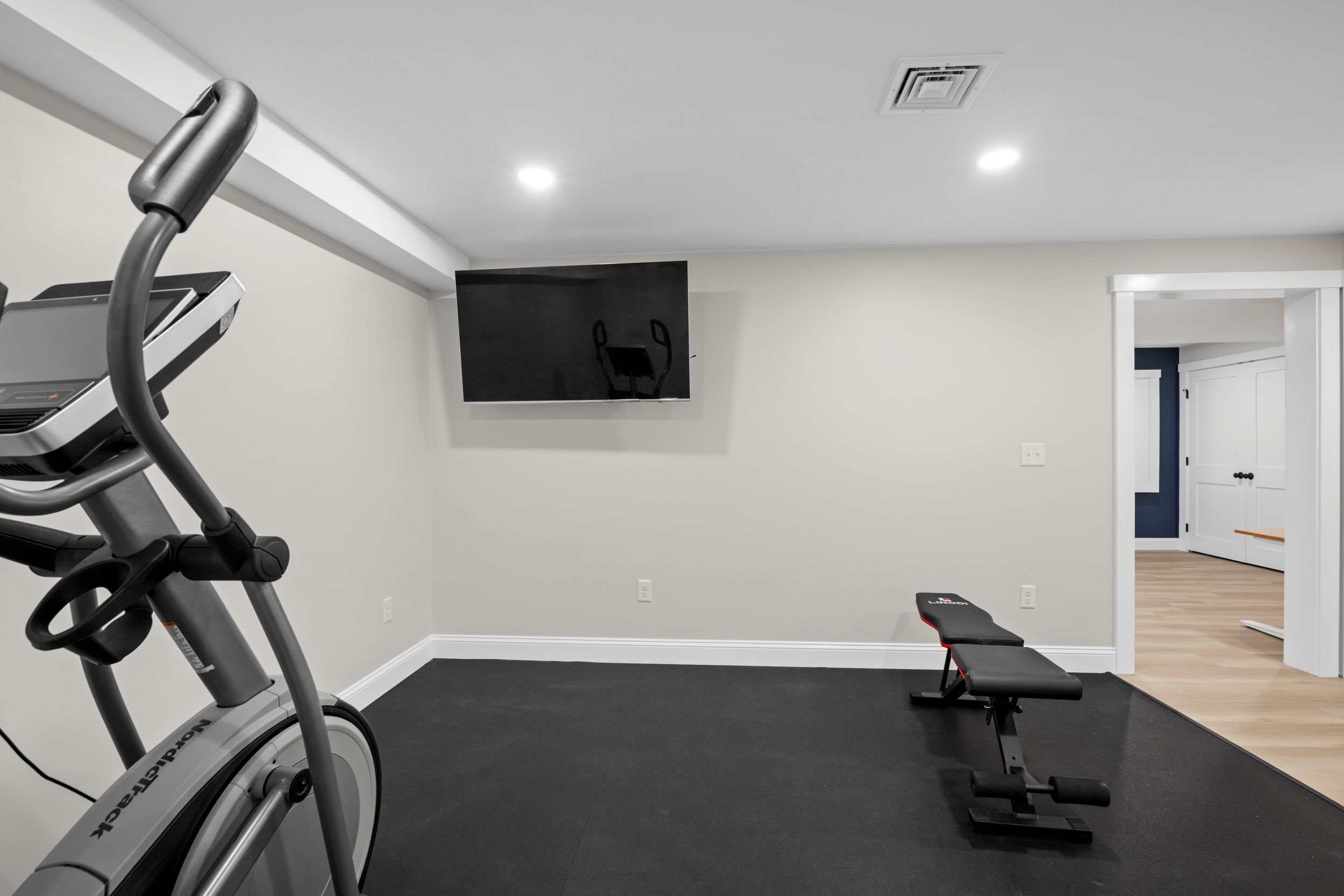 The open layout easily accommodates large fitness equipment while maintaining a bright, inviting atmosphere that motivates daily workouts.