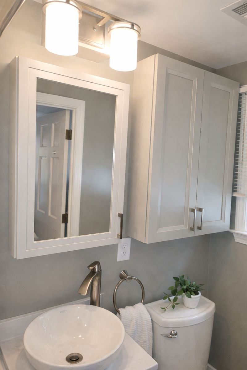 Bathroom in family room addition with custom vanity, vessel sink, and patterned tile flooring