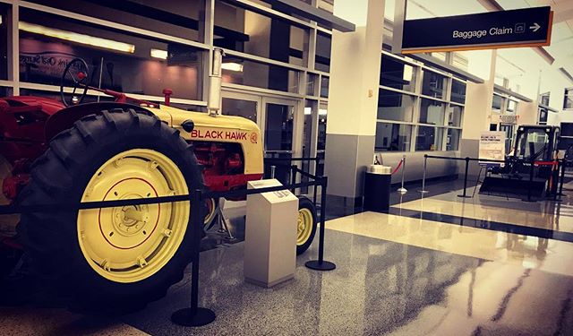 I&rsquo;m near my parents&rsquo; house.  I know this simply because there&rsquo;s farm equipment on display in baggage claim.