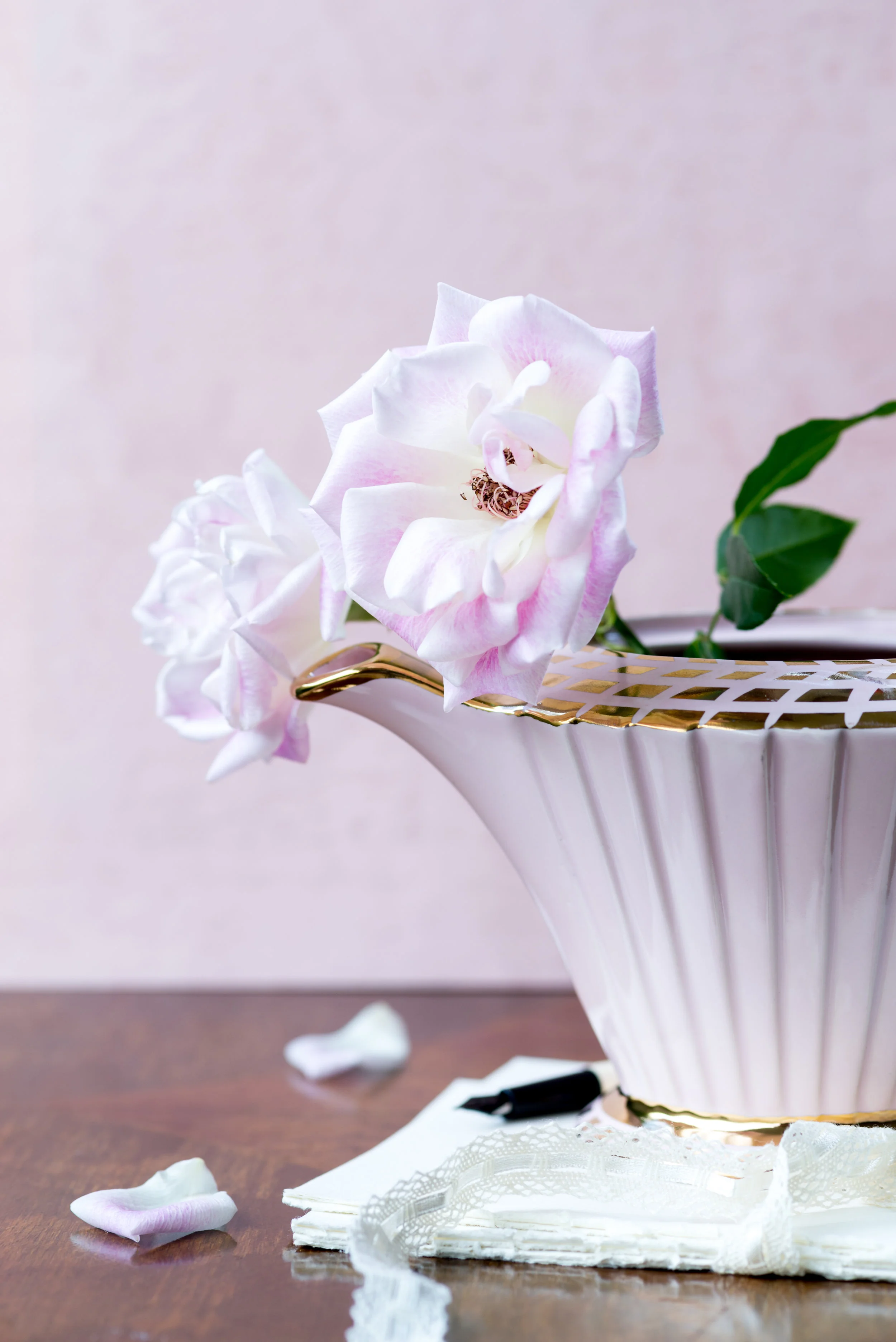 Flowers in an antique teapot with writing paper and pen.jpg