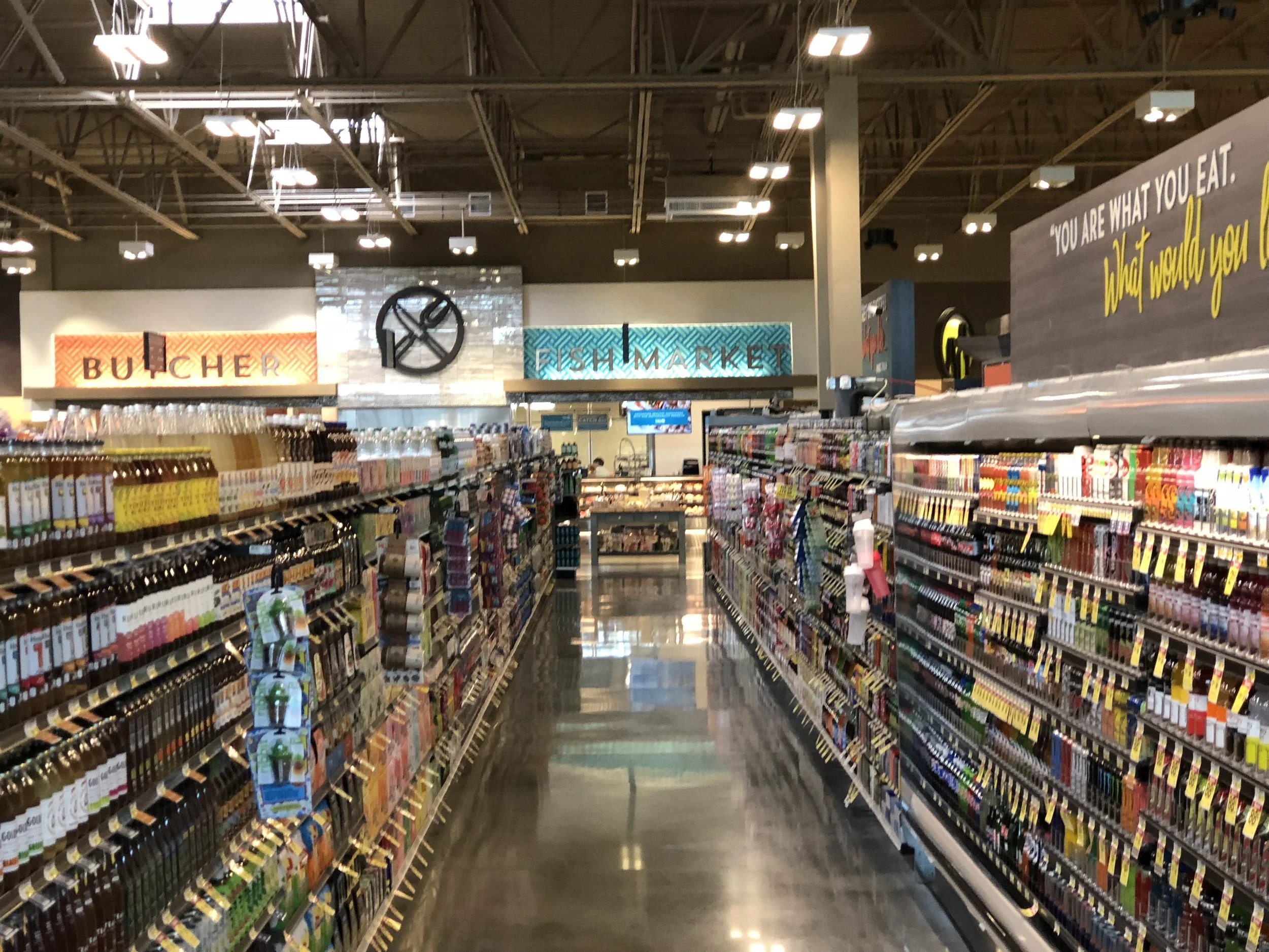 A typical store aisle with the fish market and butcher block in the background.
