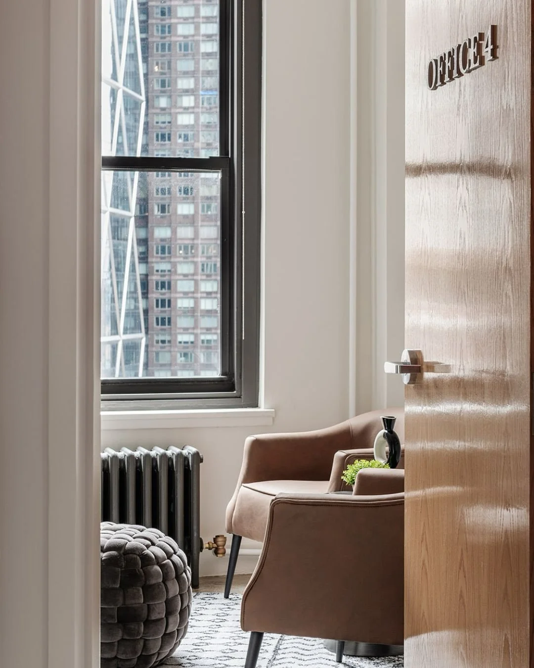 This NYC therapist&rsquo;s office started with industrial bones &mdash; stark white walls and concrete floors. Our mission was to warm it up without a renovation.  We added instant softness and personality with rugs, introduced rich colors and textil