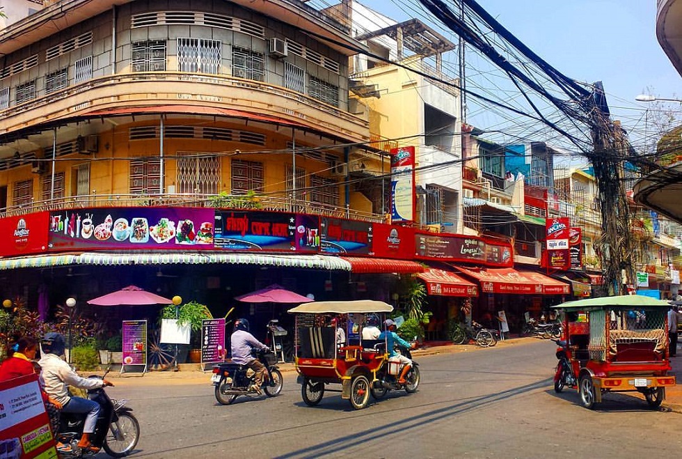 Busy Tuk Tuk drivers hustling through the streets of Phnom Penh, Cambodia