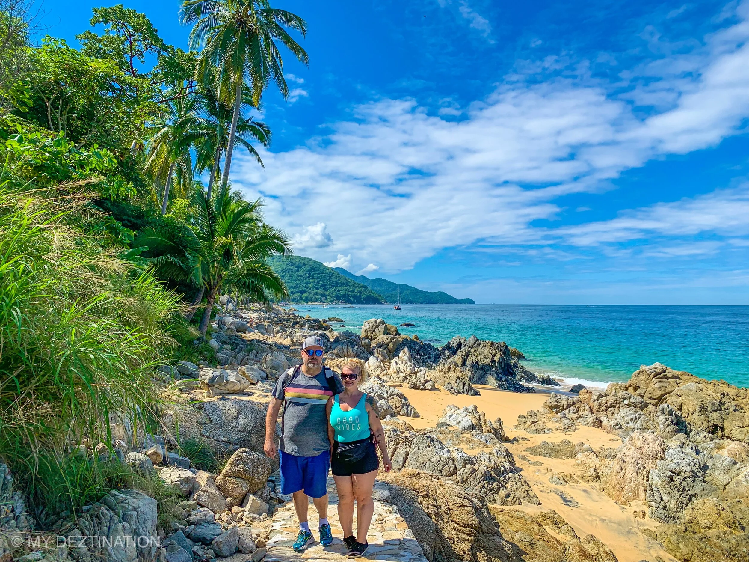Couple on sandy trail by ocean during guided My Deztination Las Ánimas hike.