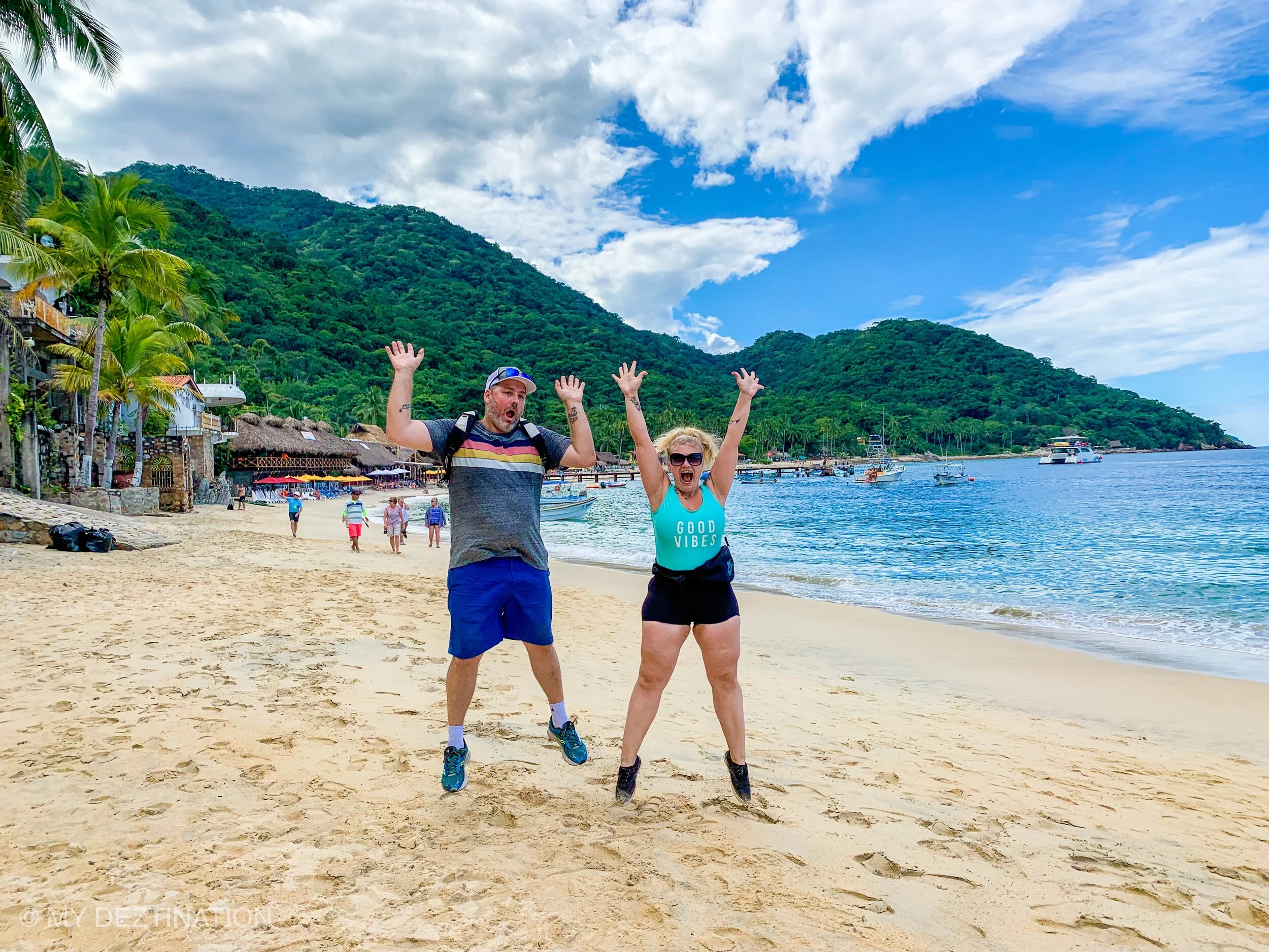 Couple celebrating, jumping on Las Ánimas Beach with My Deztination.