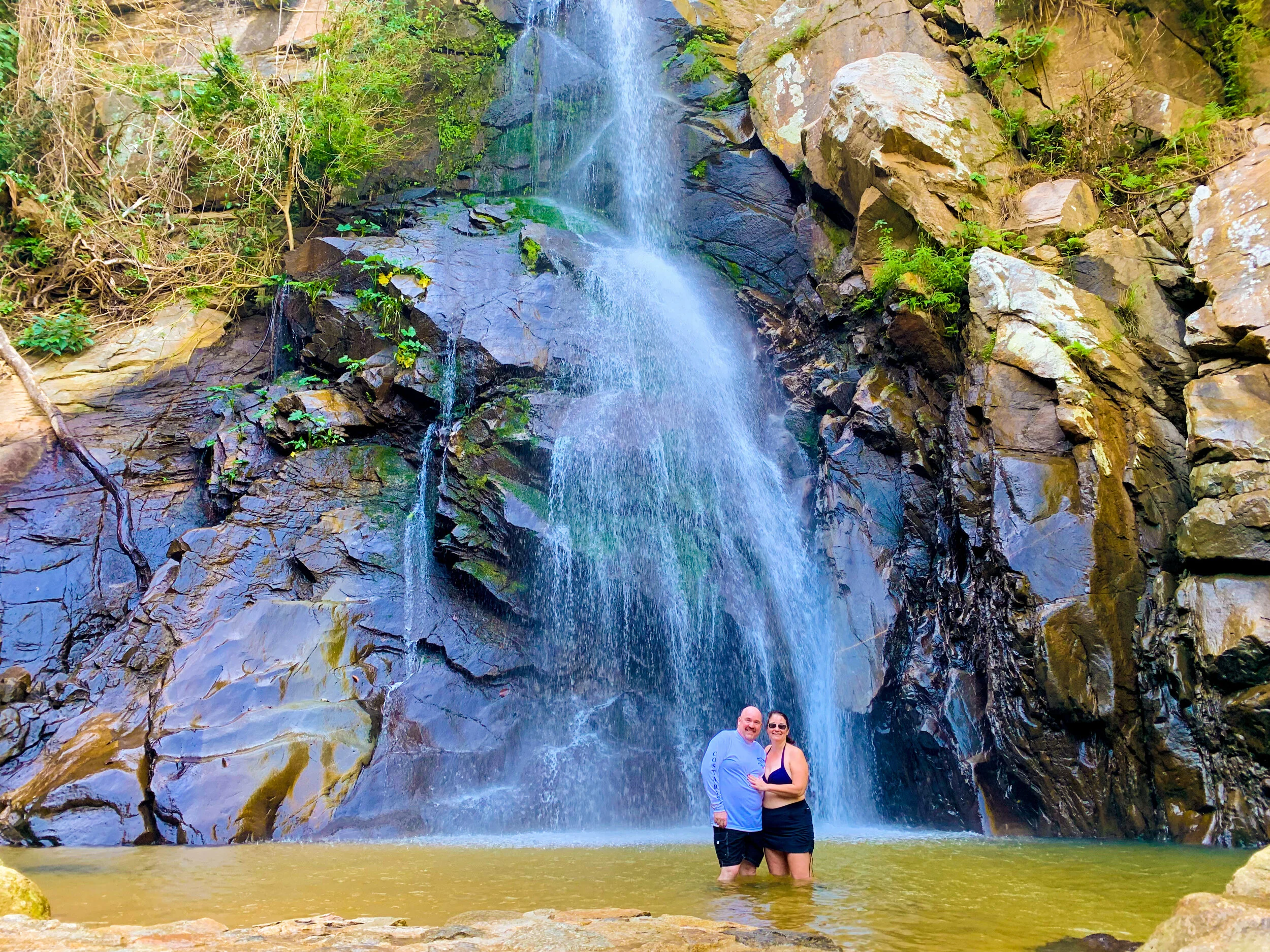 Couple swimming in Yelapa waterfall with My Deztination.