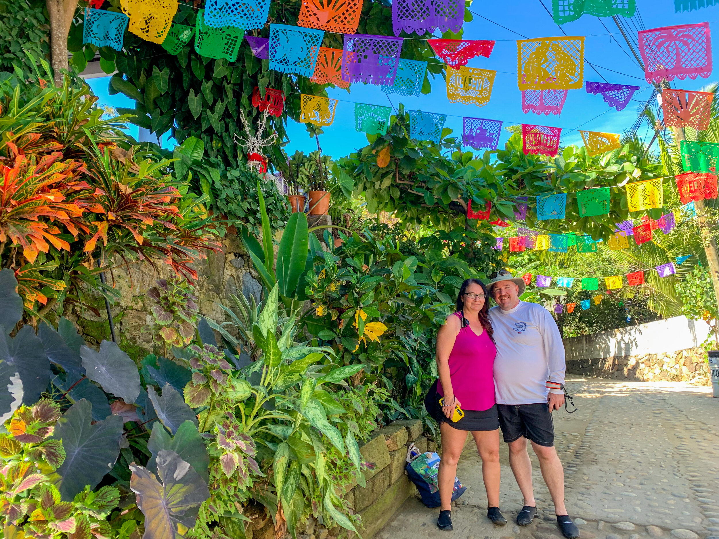 Couple smiling on a colorful Yelapa street during a guided local tour.