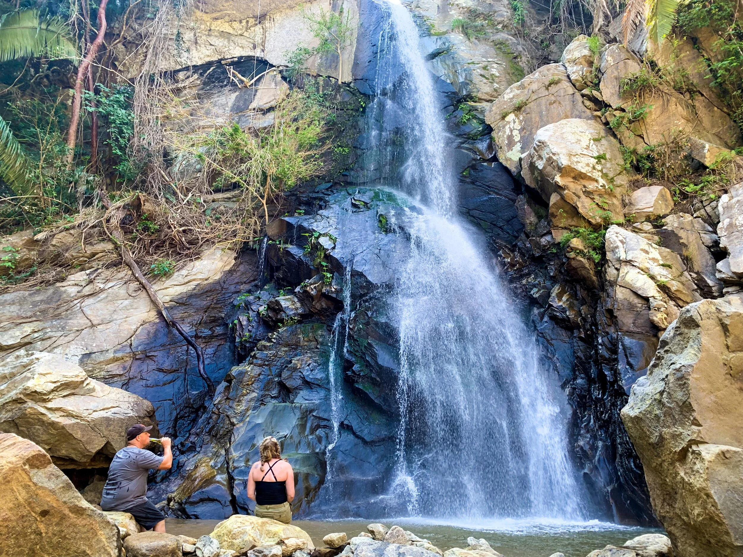Couple relaxing at Yelapa waterfall on a boutique My Deztination tour.