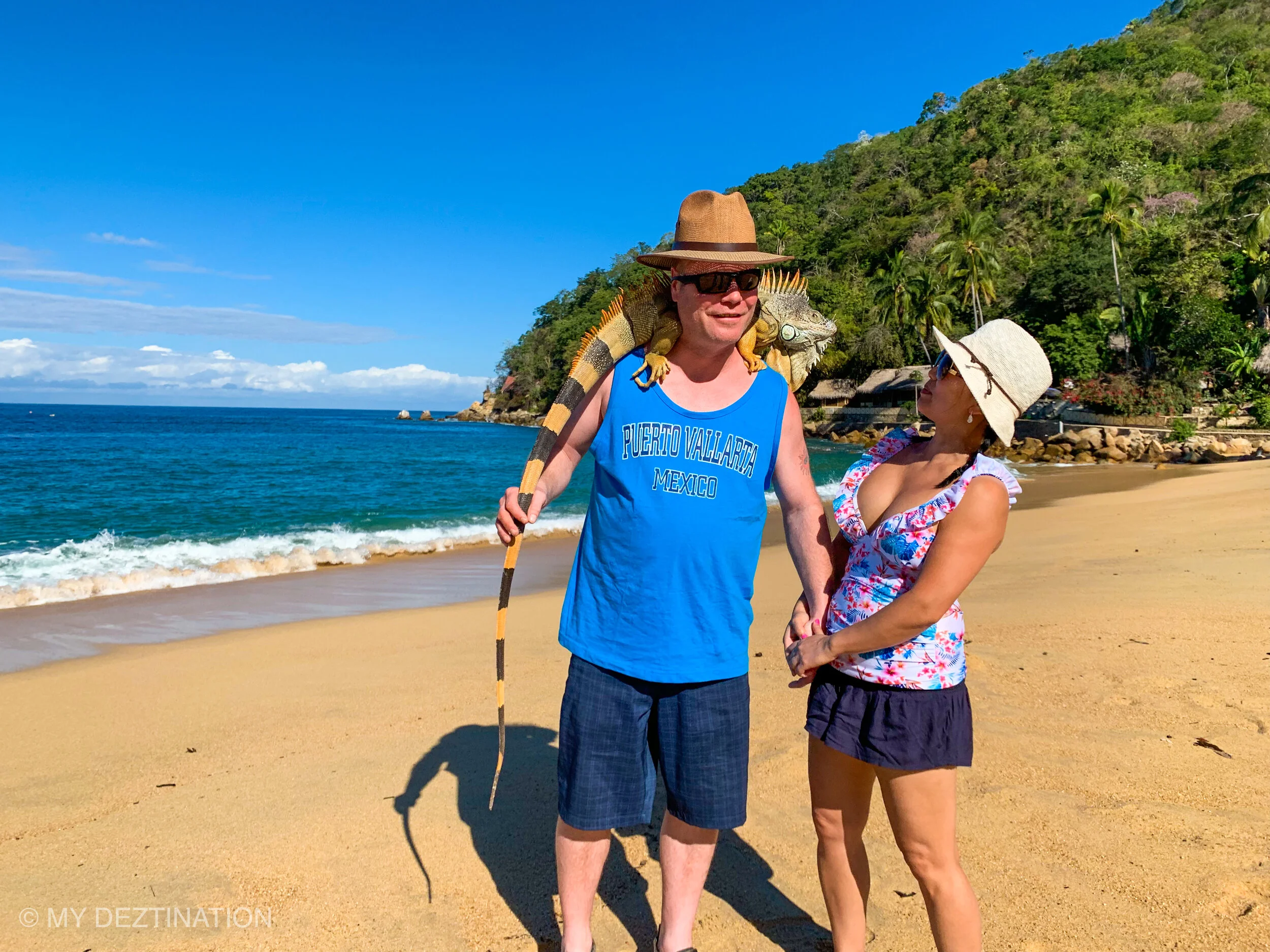 Couple on Yelapa Beach, man posing with iguana on his shoulders.