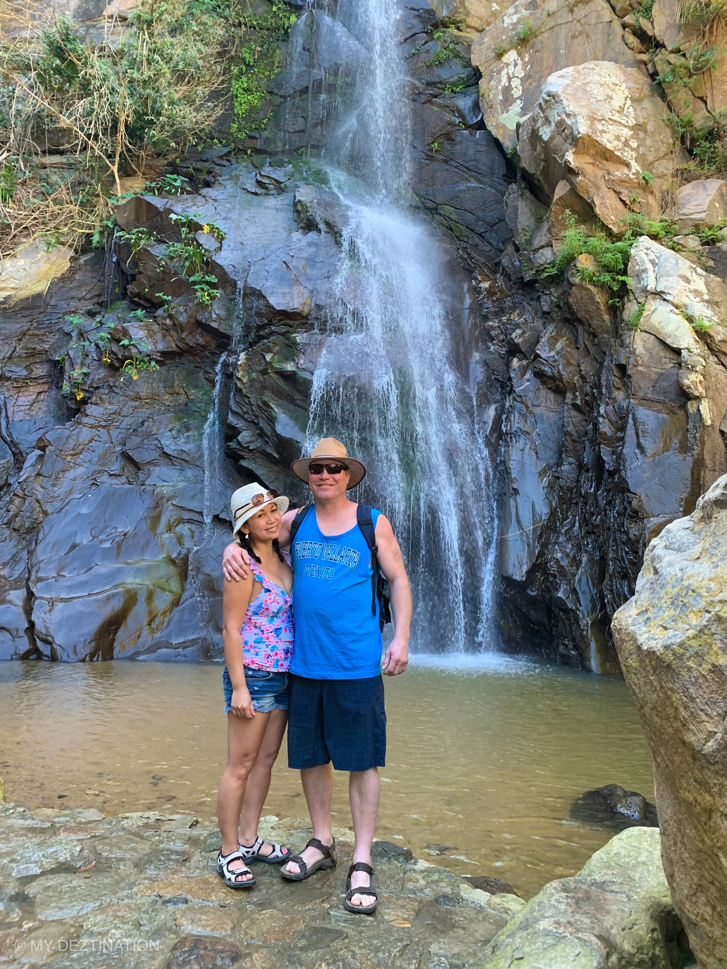 Couple smiling in front of Yelapa waterfall on My Deztination tour.