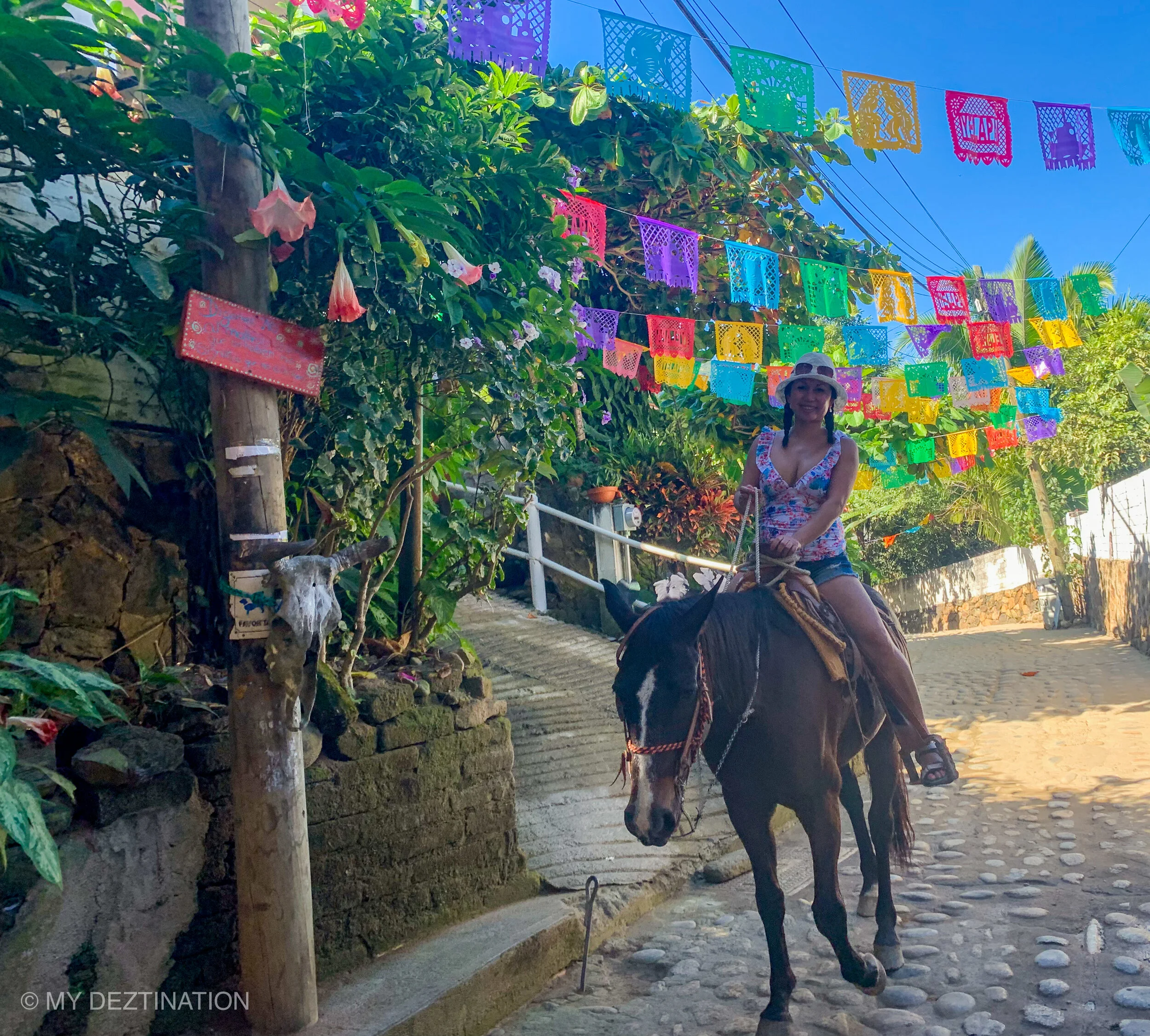 Guest riding a horse along Yelapa’s cobblestone streets.