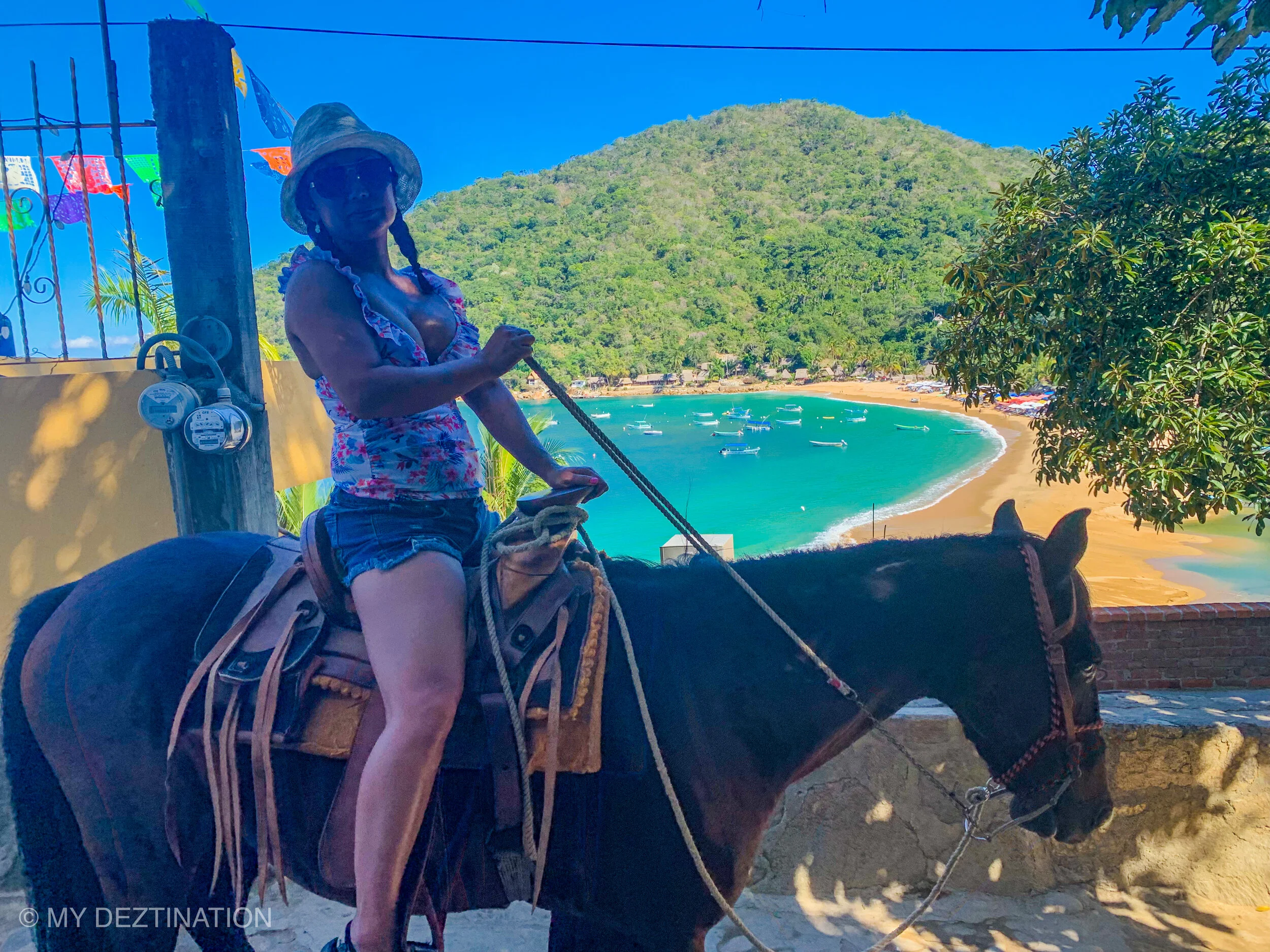Woman on horseback at scenic viewpoint during Yelapa tour.