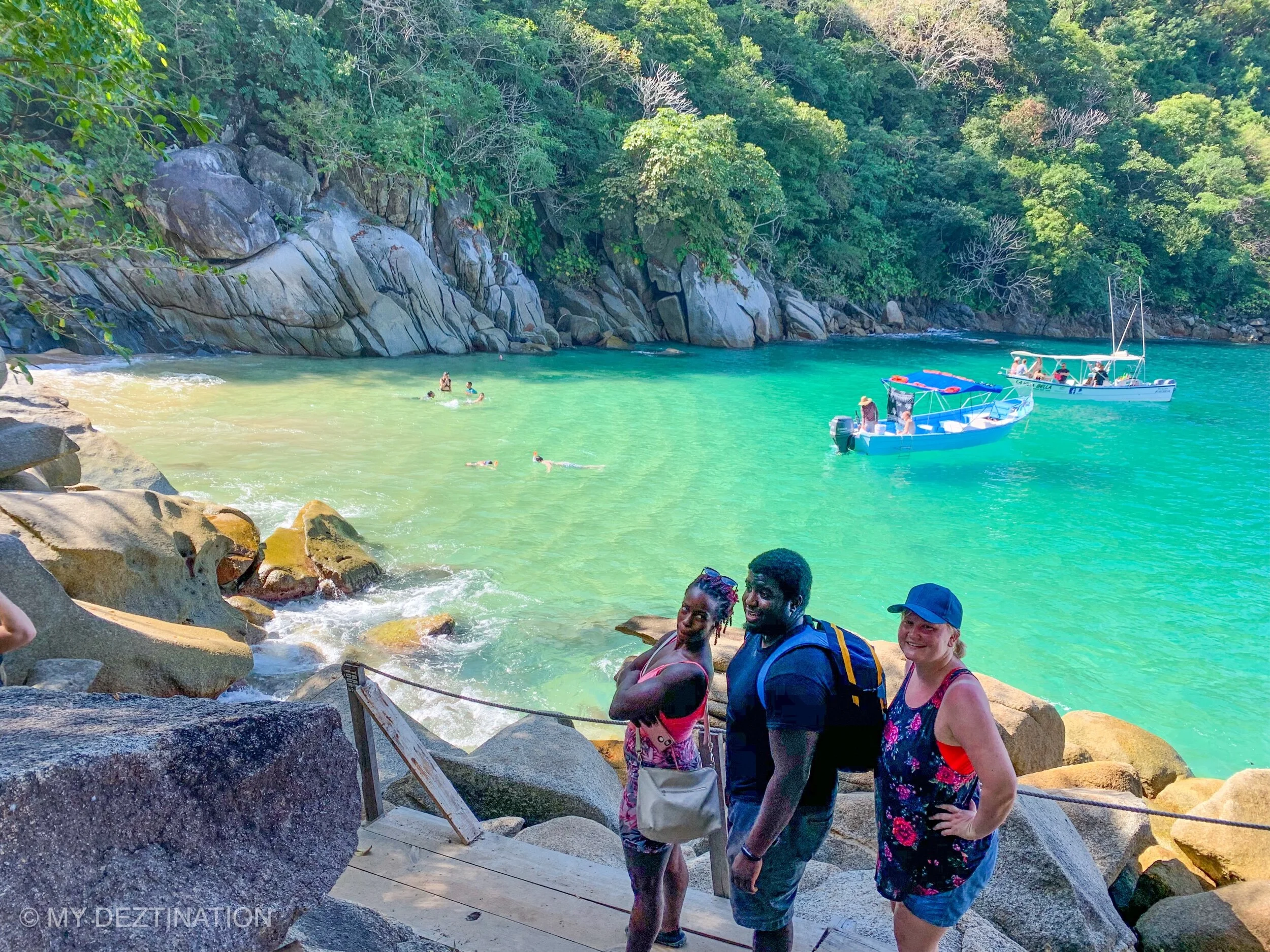 Group walking coastal trail down to Playa Colomitos with My Deztination.