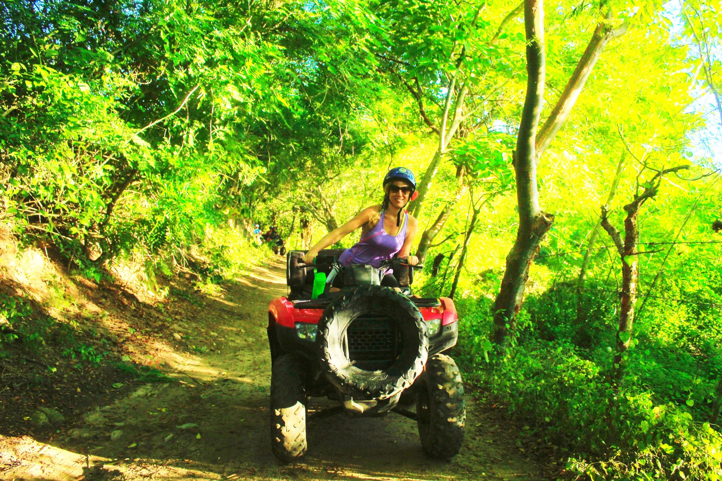 Guest smiling while riding ATV on My Deztination adventure tour.