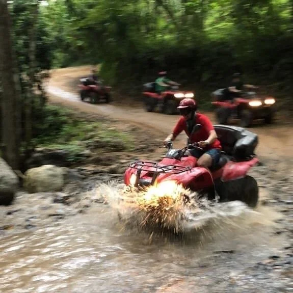 ATV splashing through water on My Deztination jungle ride.