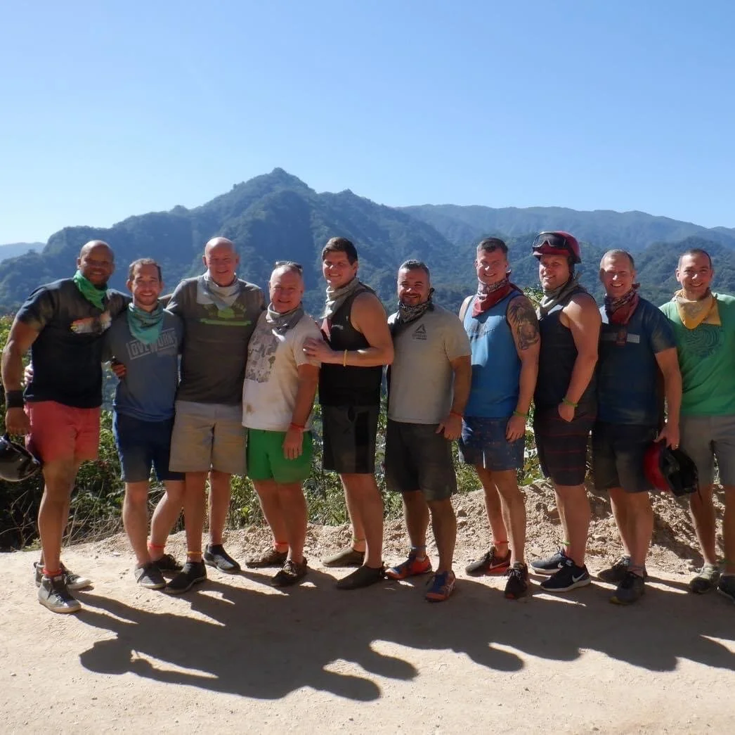 Group smiling with mountains behind them on My Deztination ATV tour.