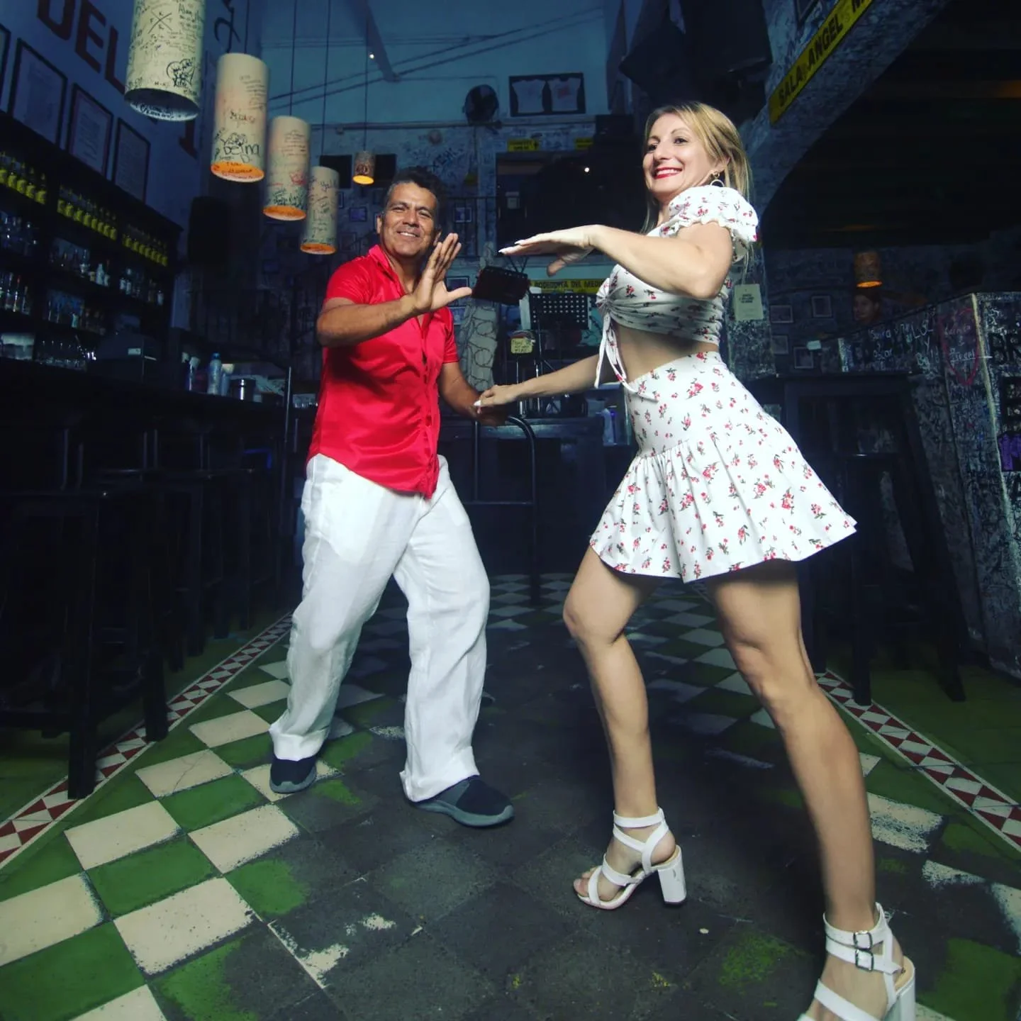 Salsa teacher instructing guest inside La Bodeguita with My Deztination.