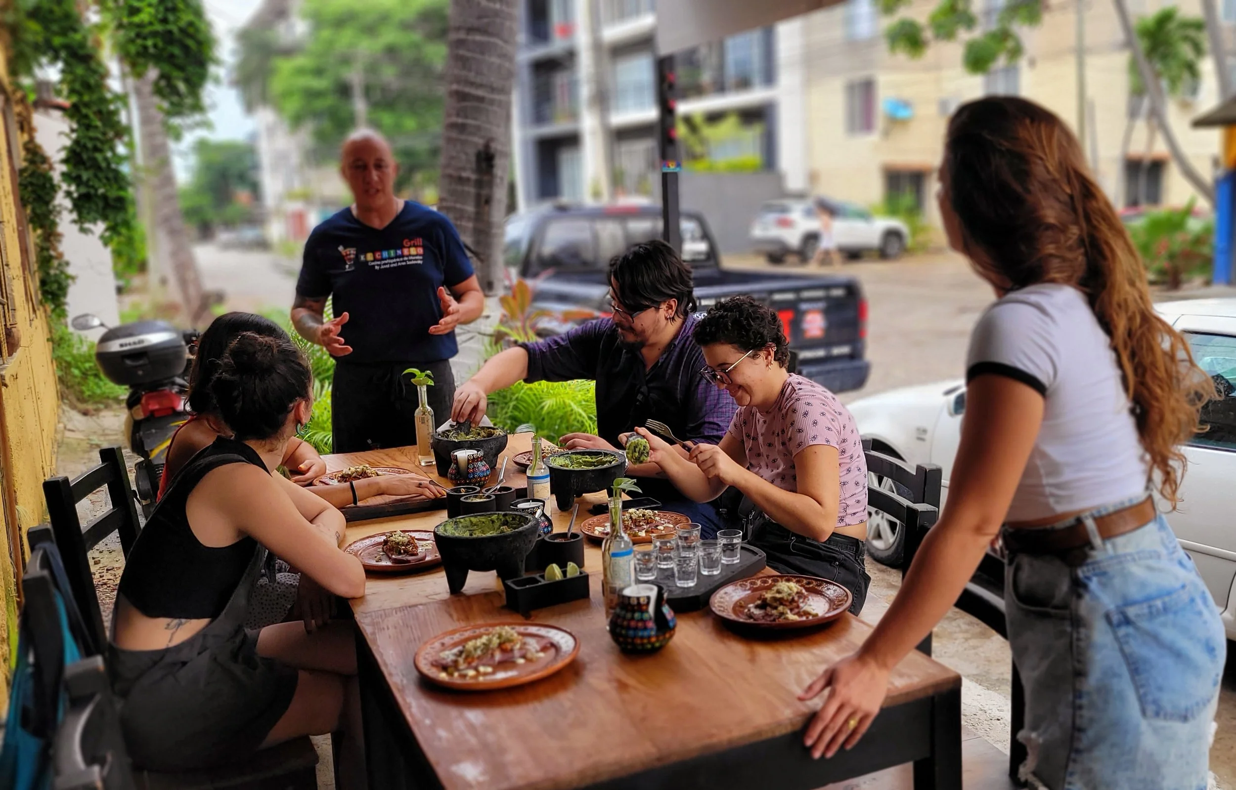 Group of guests seated together learning recipes in My Deztination cooking class.