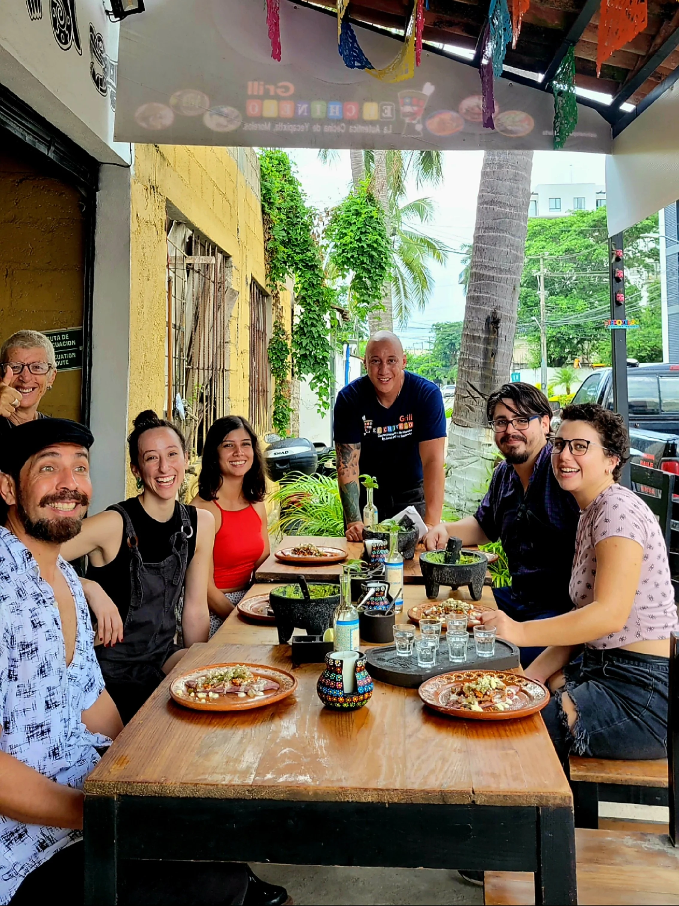 Guests gathered around table enjoying My Deztination Puerto Vallarta cooking class.
