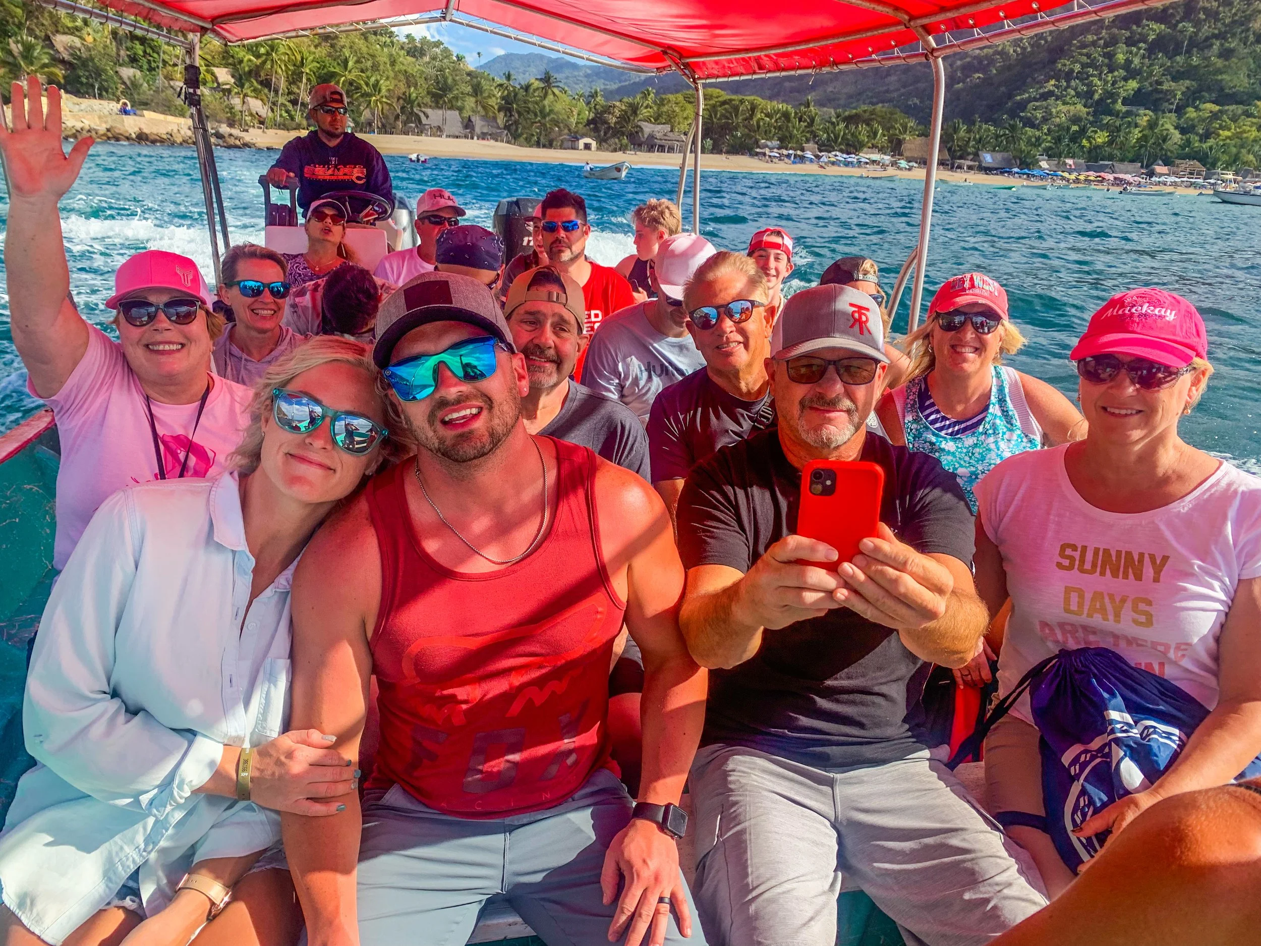 Large group smiling together on private boat with My Deztination.