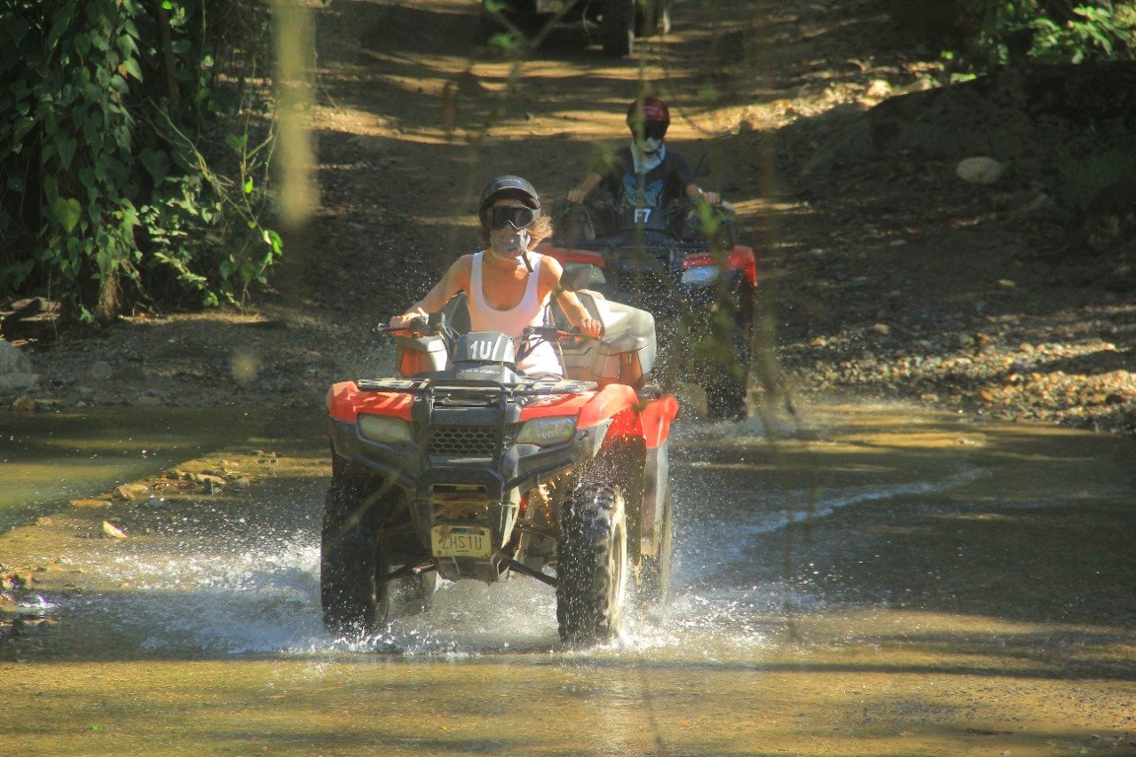 Two ATVs crossing river water on My Deztination Puerto Vallarta tour.