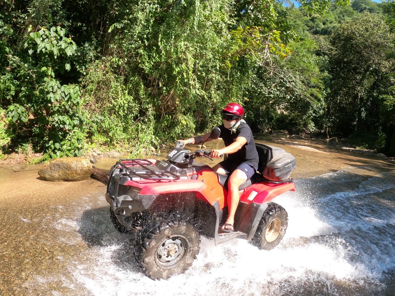 Guest with bandana splashing through water on My Deztination tour.