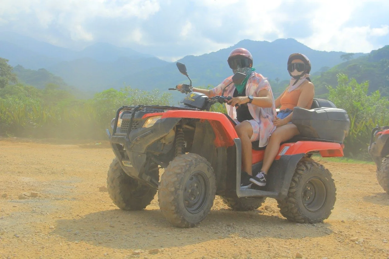 Couple posing on parked ATV during My Deztination adventure.