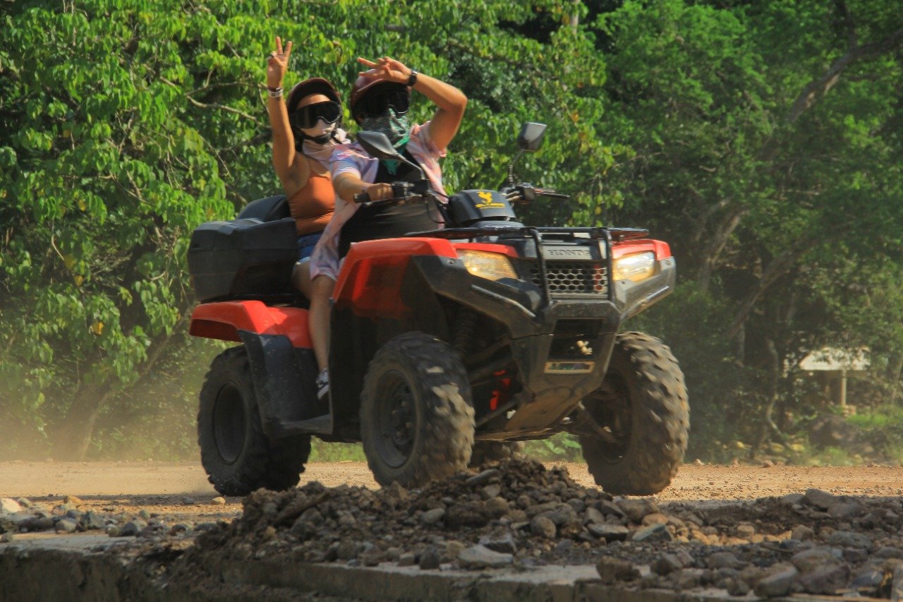 Couple riding ATV on My Deztination Puerto Vallarta adventure.
