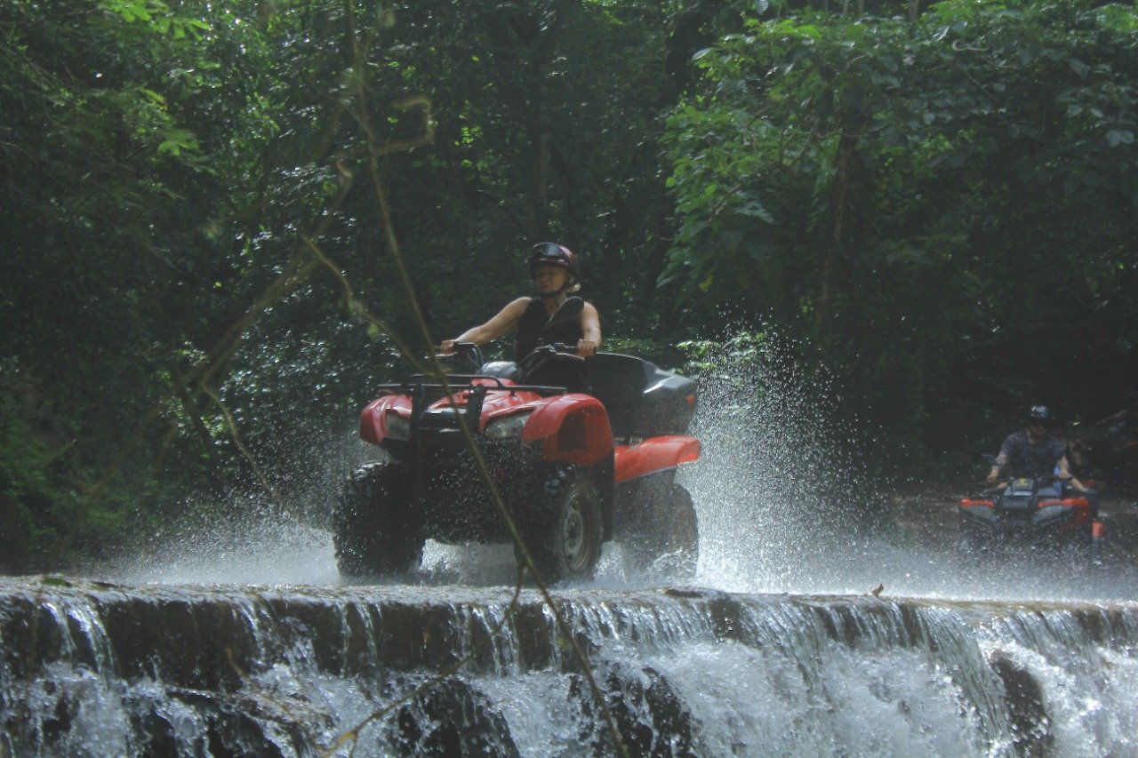 Guest splashing ATV through water crossing on My Deztination ride.