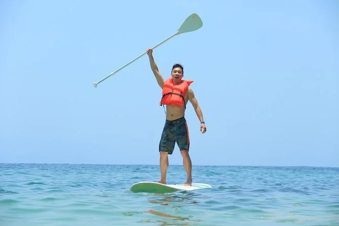 Guest paddling on board Majahuitas Luxury yacht excursion.