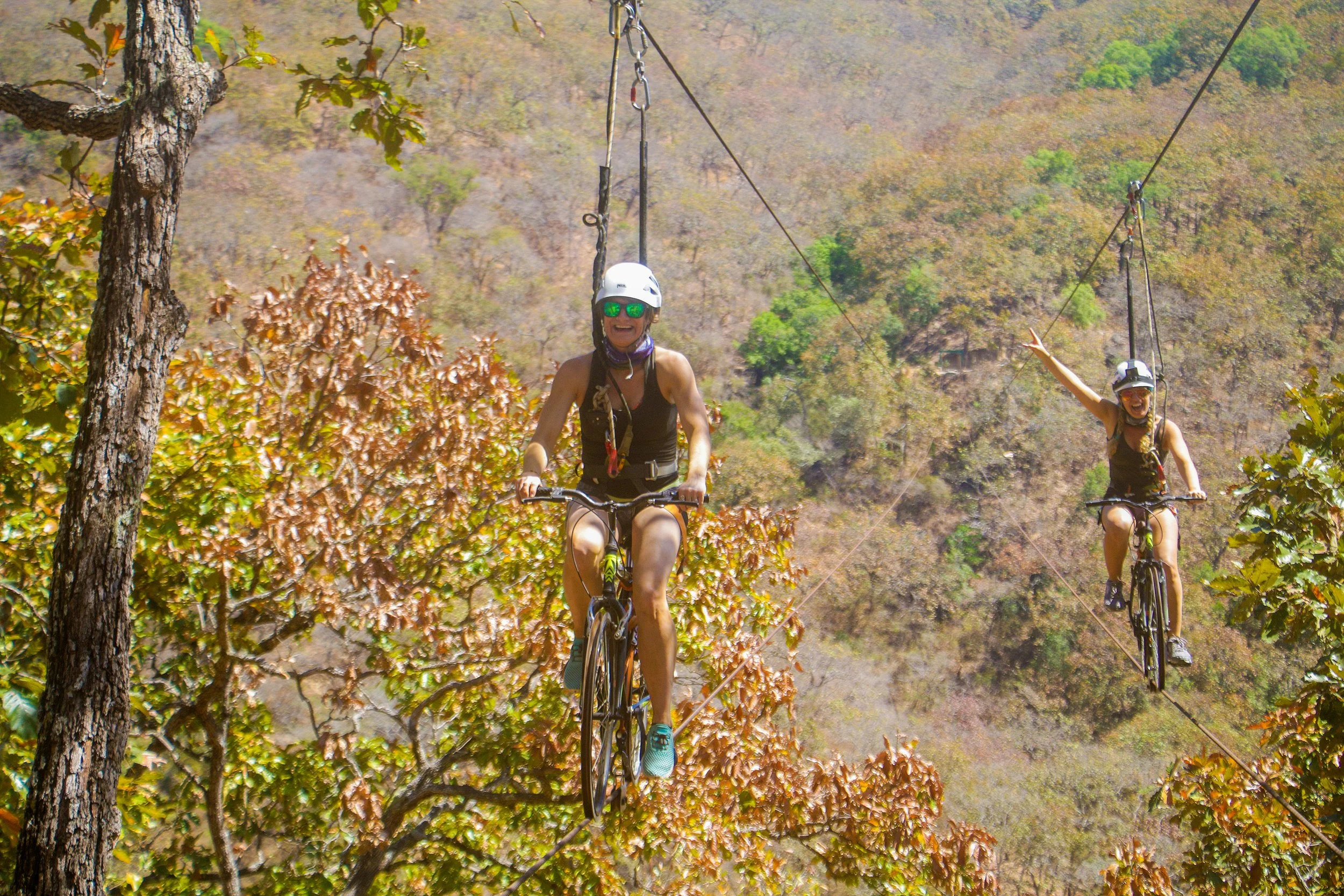 Guests riding the bike flight zip line with My Deztination in Puerto Vallarta.
