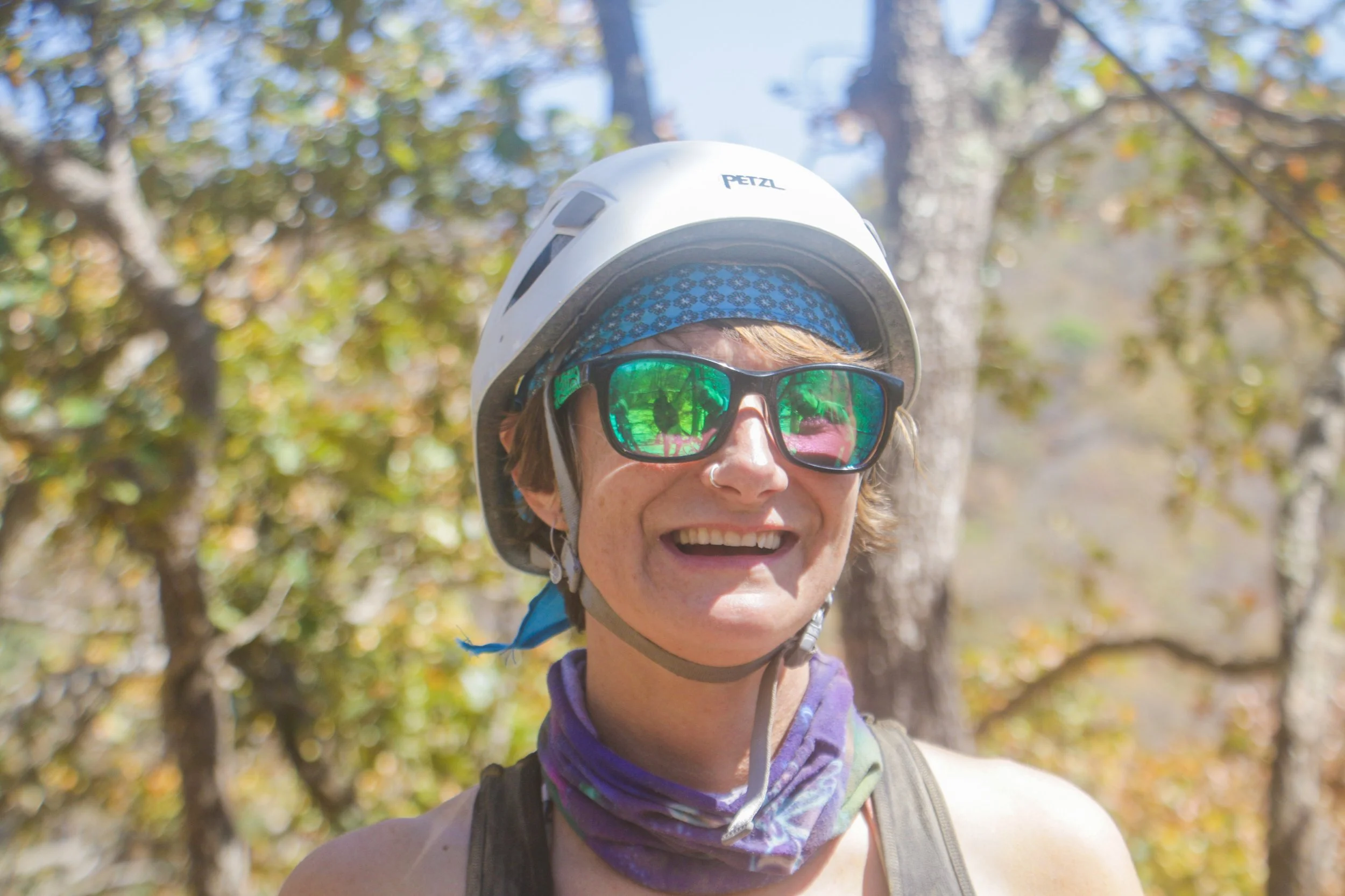 Guest smiling with sunglasses and helmet during My Deztination ATV tour.