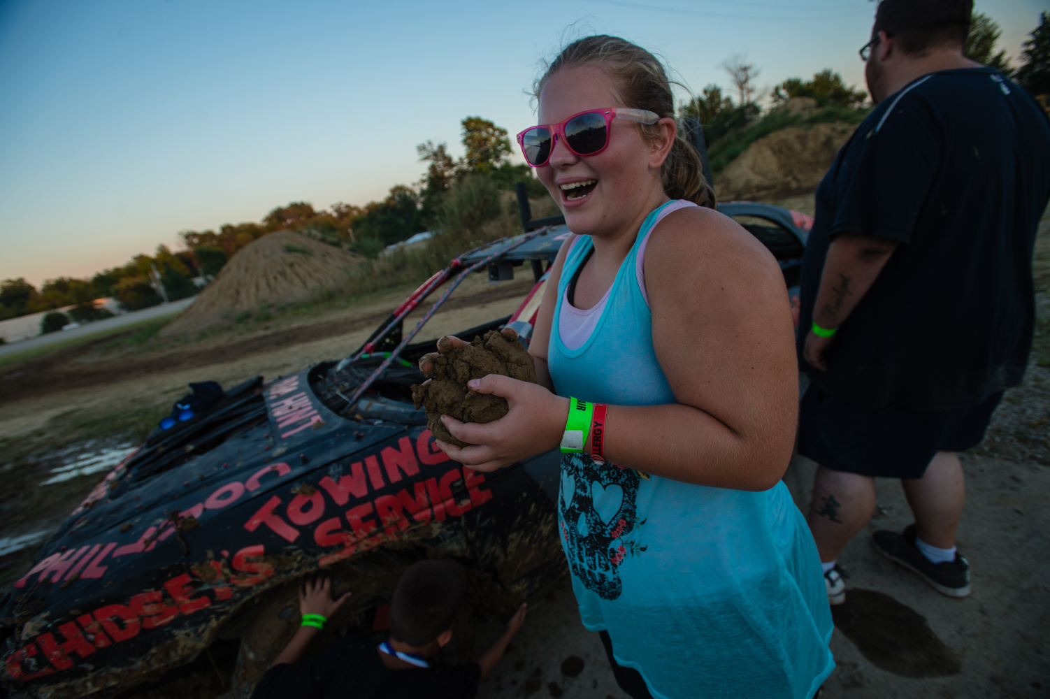 A contestant's sister collects the mud that falls off winning cars from each race.