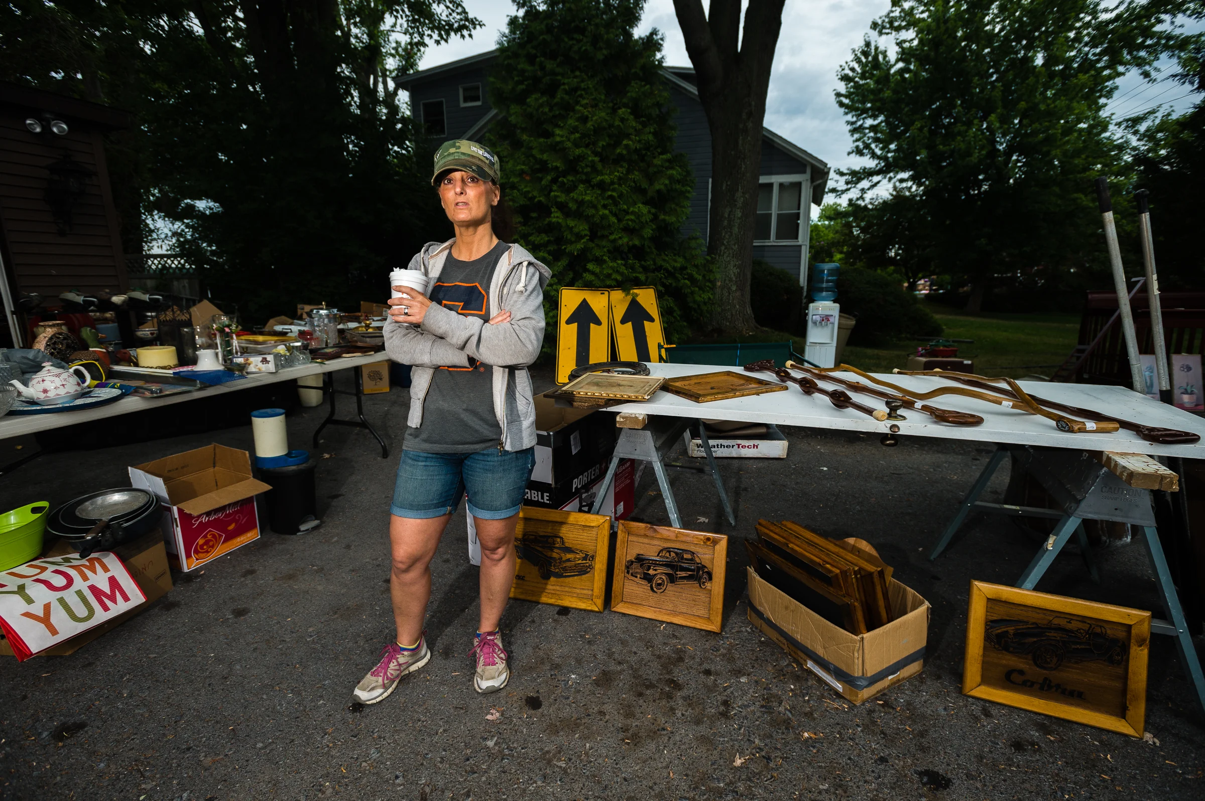 Village of Cayuga resident Alicia Maywalt helps oversee a neighbor's collection of goods for sale during the annual "50 Mile Yardsale", Saturday, July 30, 2016 along Route 90 in the Cayuga Lake region of the Finger Lakes, New York.