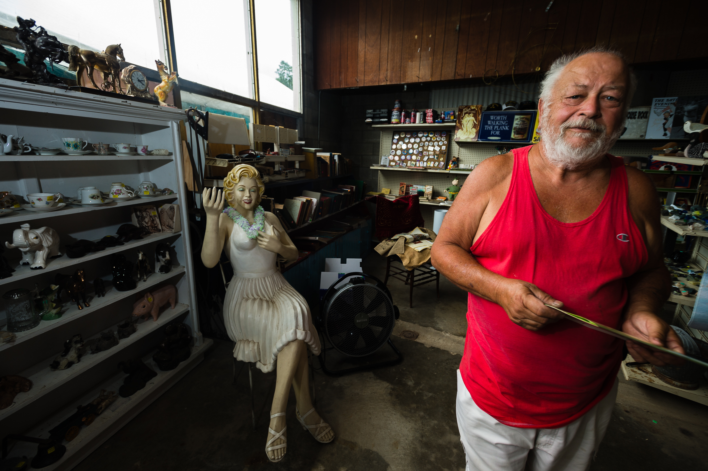 Cayuga Lake resident Dick Dwello talks about acqusition of his goods for sale during the annual "50 Mile Yardsale", Saturday, July 20, 2016 along Route 90 in the Cayuga Lake region of the Finger Lakes, New York. Mr. Dwello, considered by a handful of other residents as having been around for the beginning of the commiunity event that draws people from as far away as Canada, refers to himself as, " ... one of the stupid one's who still enjoys it."