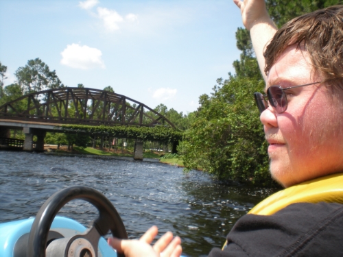 My son boating in a personal watercraft on the Sassagoula River, Port Orleans Resorts, Walt Disney World, Florida