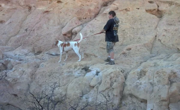 The author with my hound dog, Jake, as Sandstone Bluff, El Malpais State Park, NM