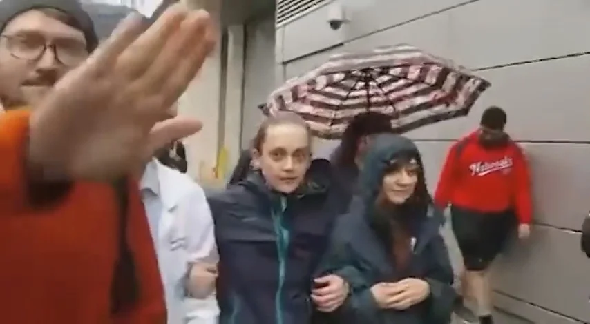 A marcher tries to block the camera's view of Dr. Pan with his hand - Still from PANdemic of Lies at the March for Science