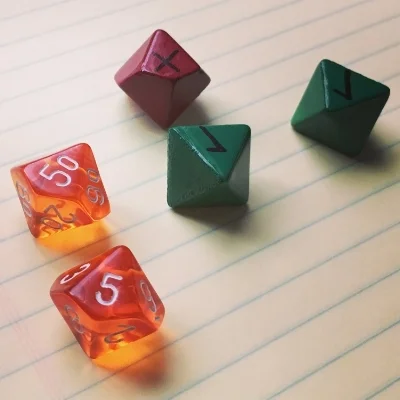The prototype advantage and challenge dice used in playtesting.