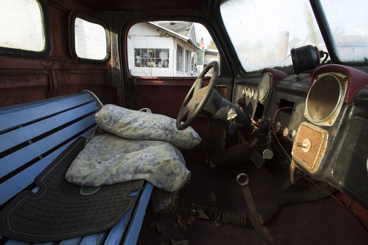 Dale Blosser remodeled the interior of his truck with an old park bench for a seat, and wrench for a gear shifter. Blosser has been living off of unemployment checks since he was laid off from his last job. He enjoys building projects like this truck with scrap wood and metal to help pass the long days.