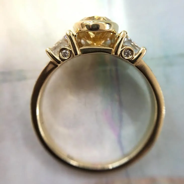 Open bezel for center diamond and little diamonds on the sides.