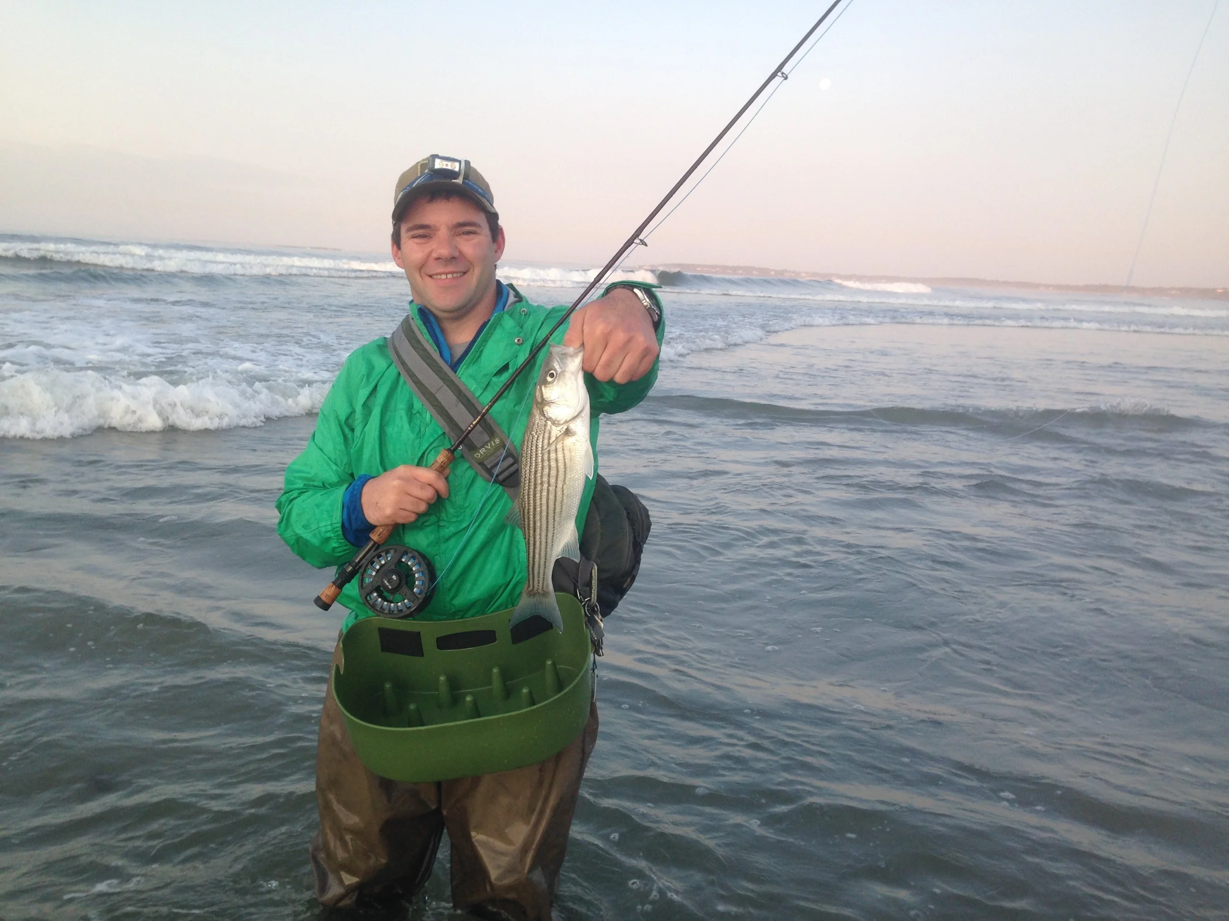 Anadromous Adventures guide and owner, Zach, with an early season schoolie from the beach.